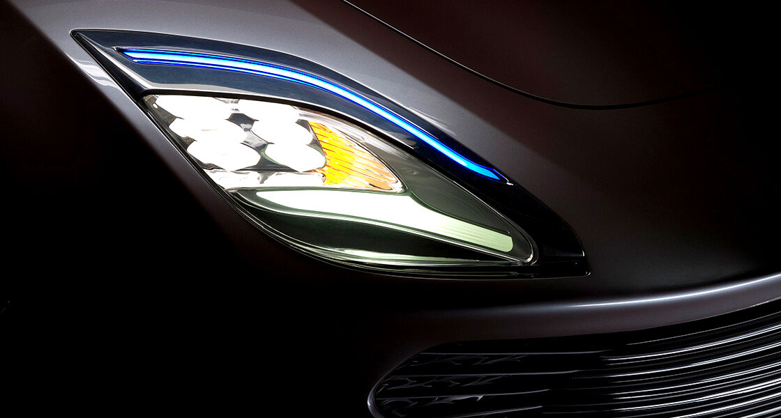 Extreme close-up view at a head light of i-oniq with the lights on