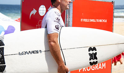a man holding a white surfboard