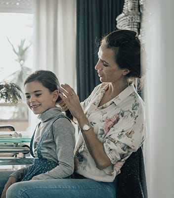 mom is touching a child's hair