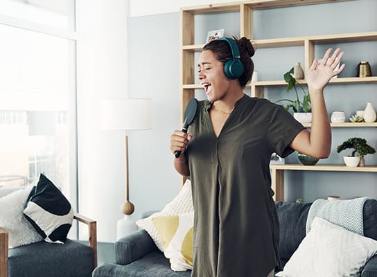a woman sings in living room