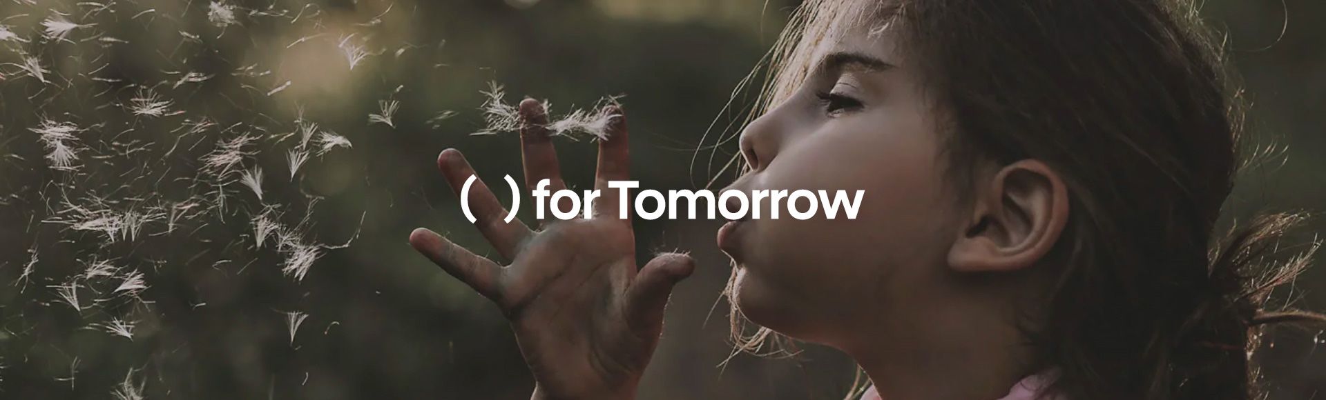 A young girl with brown hair blows a dandelion seed head. The white text reads “( ) for Tomorrow.”
