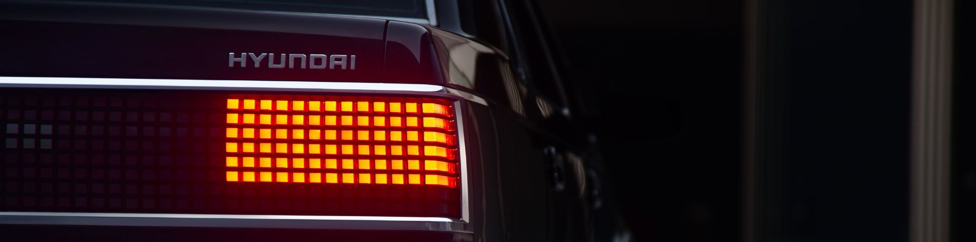 A close up of the Parametric Pixel taillight on the Heritage Series Grandeur lit up in orange.