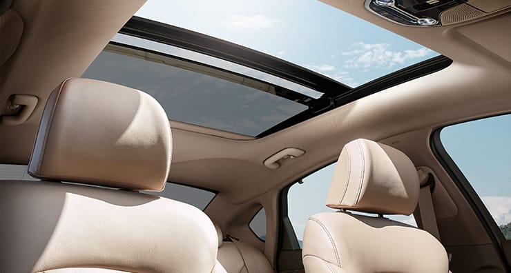 Low view of dark brown interior with sunroof opened on a clear day