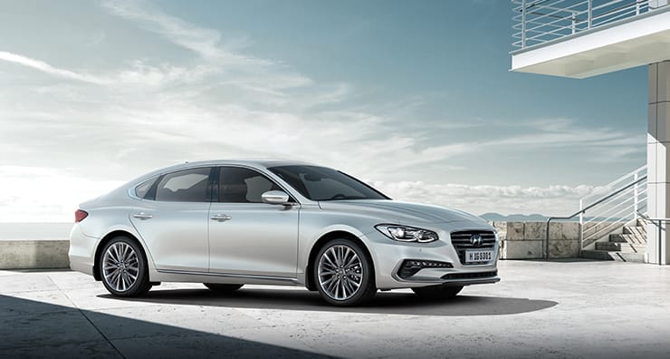 Right side front view of white cream Azera parked outside.