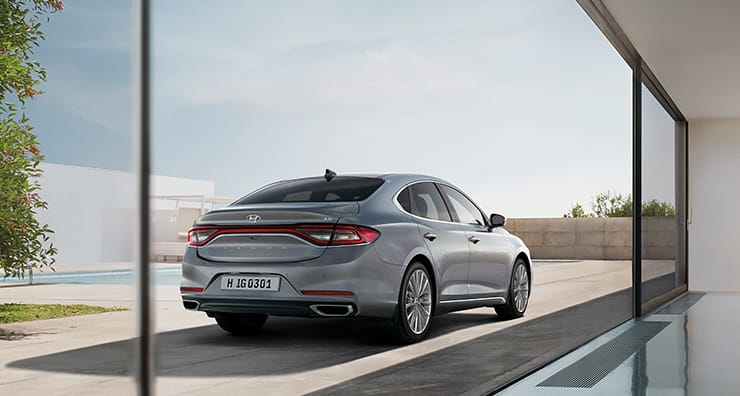 Right side rear view of silver Azera parked outside.