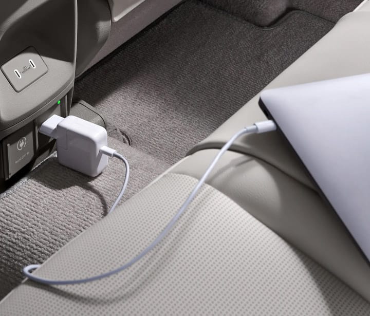A laptop charging through the indoor V2L port inside the all-new NEXO.