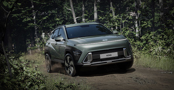 The all-new KONA driving through the forest