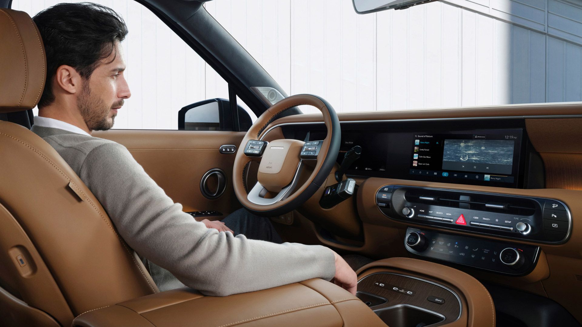 A man stting in the driver's seat inside the all-new PALISADE
