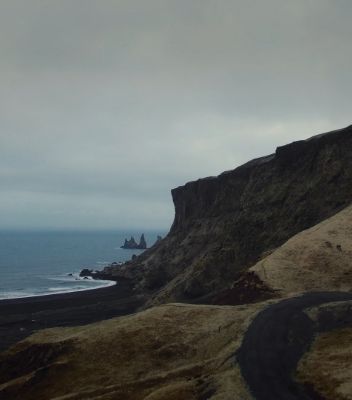 The mountainous Icelandic landscape meets the sea. 
