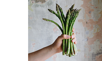 asparagus held in one hand