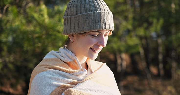 Ebba Zingmark with woolen hat and towel after her cold swim in the lake Bernsteinsee
