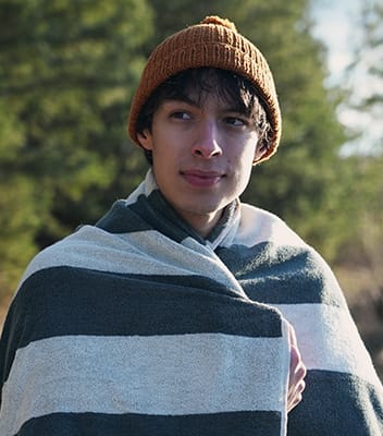 Ebba Zingmarks friend Sean with woolen hat and towel after his cold swim in the lake Bernsteinsee