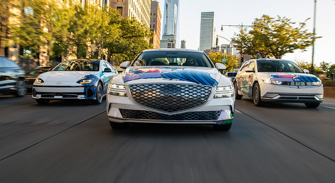 Genesis Electrified G80 sedan (center), Hyundai IONIQ 6 (left) and IONIQ 5 (right) art cars drive down the streets of New York City in a fleet with promotional wrappings to show Busan's bid to host the 2030 World Expo