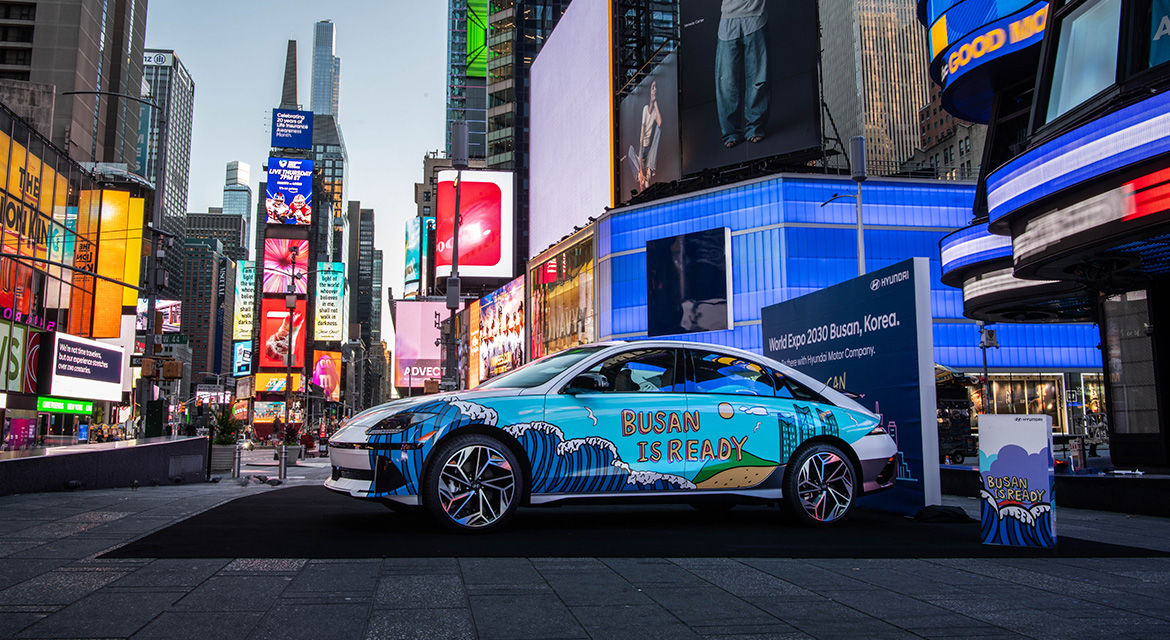 Hyundai IONIQ 6 art car exhibited at Times Square, New York, shows graffiti artwork and the slogan to promote Busan's bid to host the 2030 World Expo on its side body.