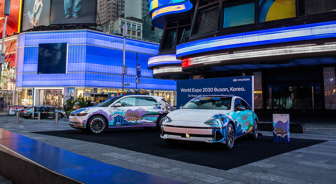 Hyundai IONIQ 6 art car exhibited at Times Square, New York, shows graffiti artwork and the slogan to promote Busan's bid to host the 2030 World Expo on its side body.