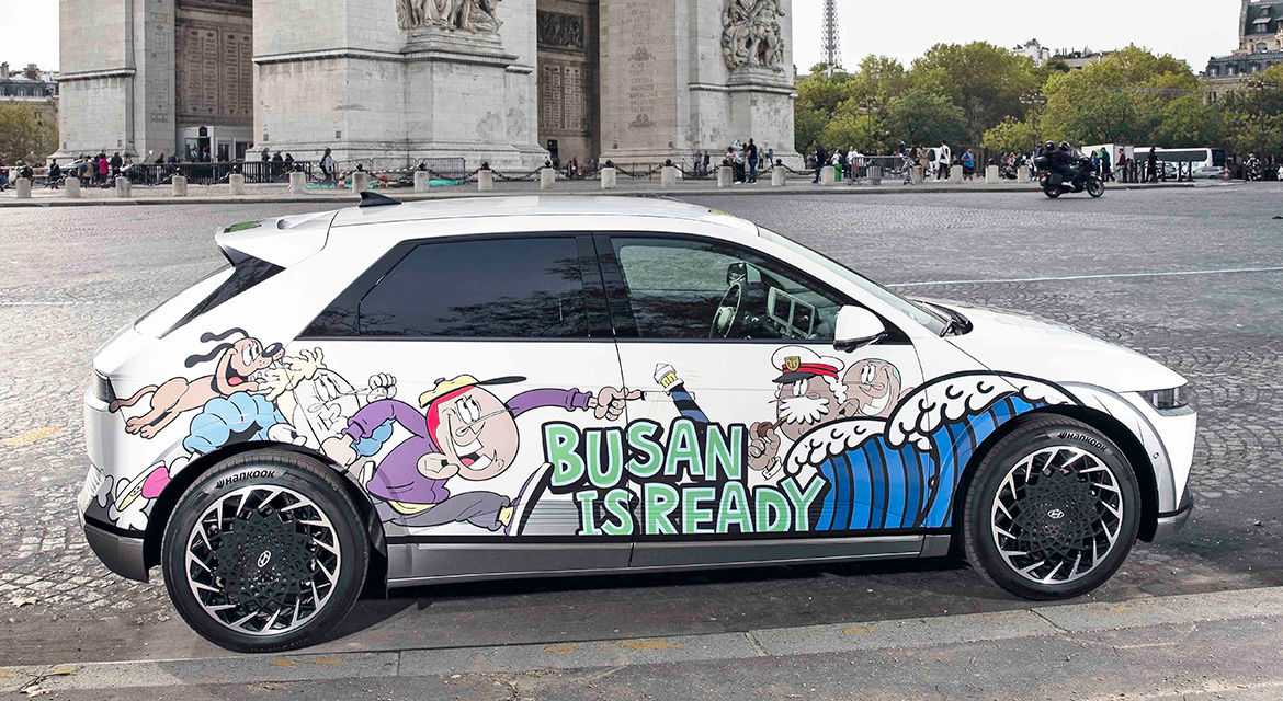 Hyundai Motor's IONIQ 5 art car is exhibited near the Arc de Triomphe de l'Étoile, Paris, showing graffiti artwork and the slogan to promote Busan's bid to host the 2030 World Expo