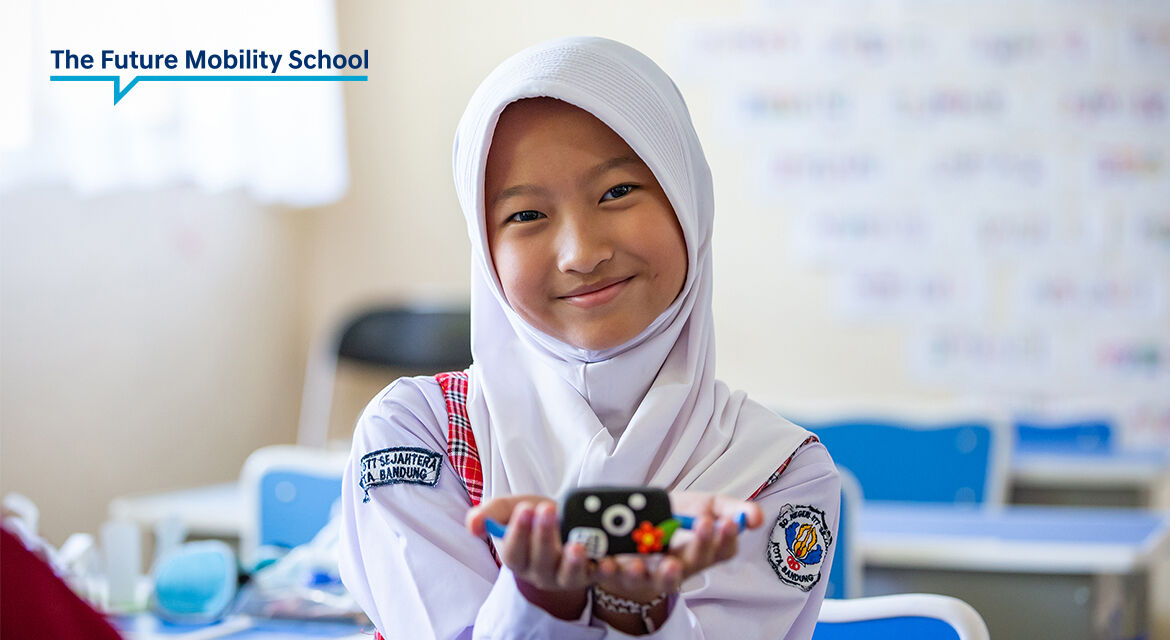 A student in the Future Mobility School class is showing her clay artwork that she made