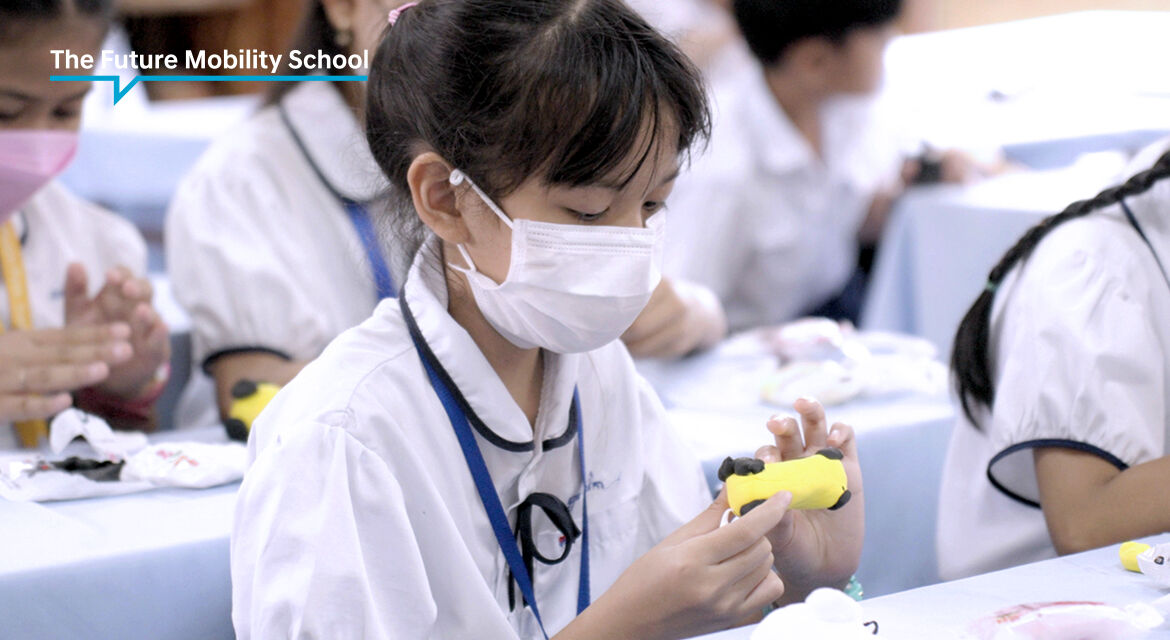 A student in the Future Mobility School class is building a clay future mobility car