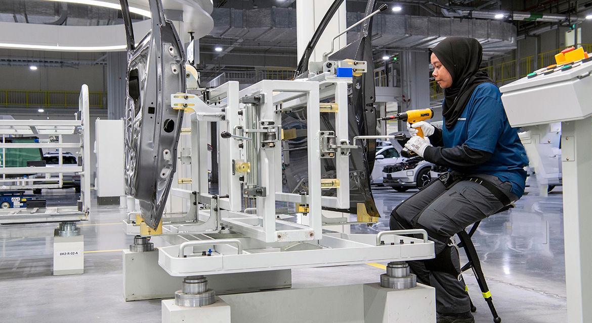 Human worker is equipped with wearable robot at HMGICS human-centered production