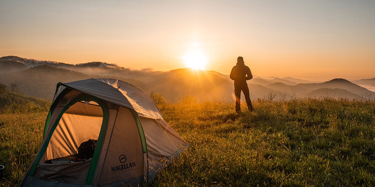 Hyundai SUV set up for chabak car camping in a Korean outdoor landscape with tent attachment