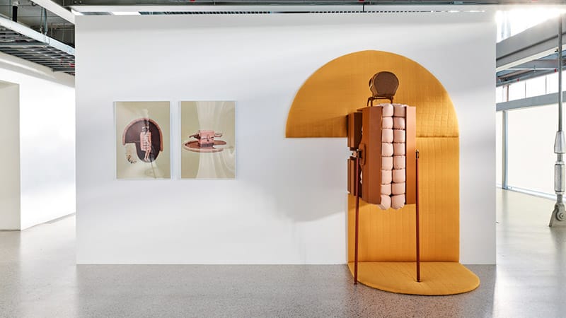 Compression Carpet 2.0, 2019, Metal (automobile jack), wood, textile, memory foam, 225x183x107cm, photographic paper print, 84x59cm