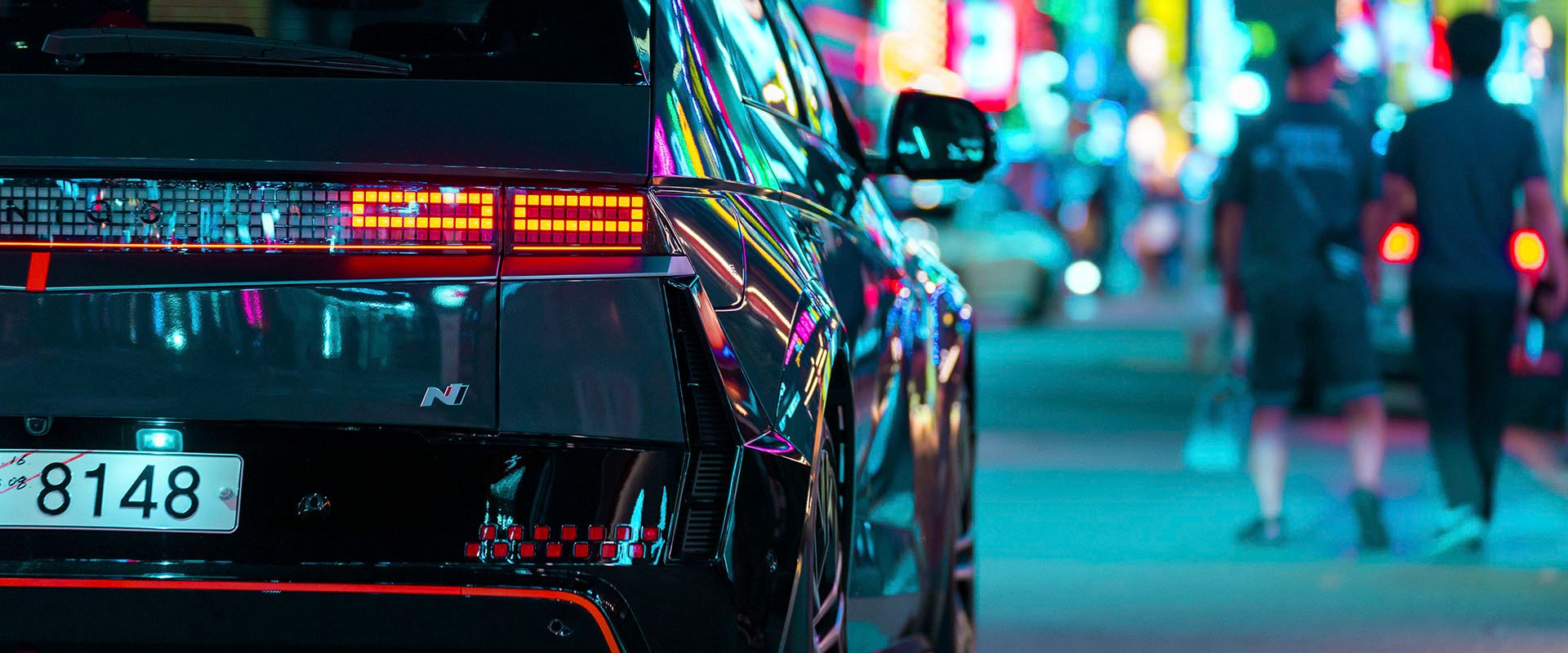 Seoul's Gangnam streets come alive at night, bathed in a neon glow and buzzing with atmosphere