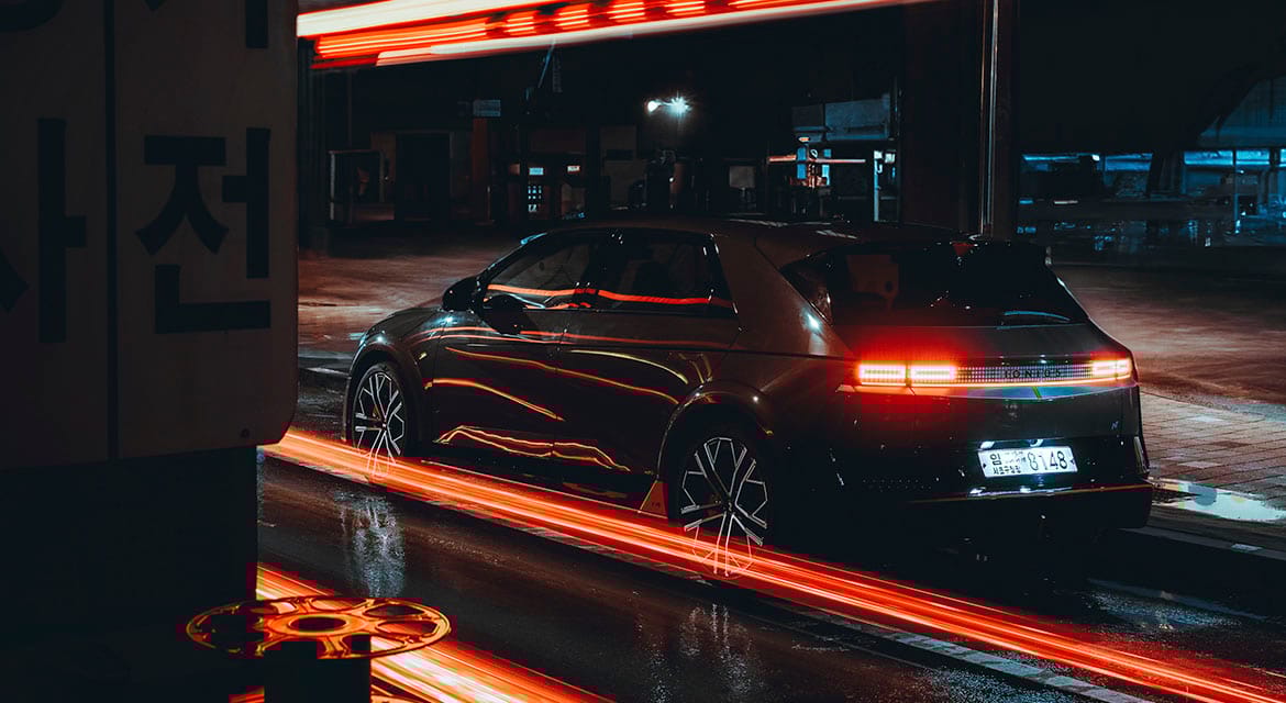 Contrasts in color are everywhere; Seoul's industrial buildings take on a different appearance under the reflected red glow of tail-lights