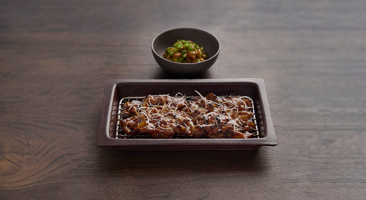 This entrée features two distinct pork cuts: belly and cheek, served with Gangdoenjang, a fermented soybean and tofu stew.