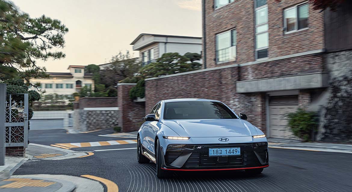 The Ioniq 6 N, finished in Performance Blue Pearl, cuts a distinctive figure as it cruises through the peaceful streets of Seongbuk-gu at dawn.