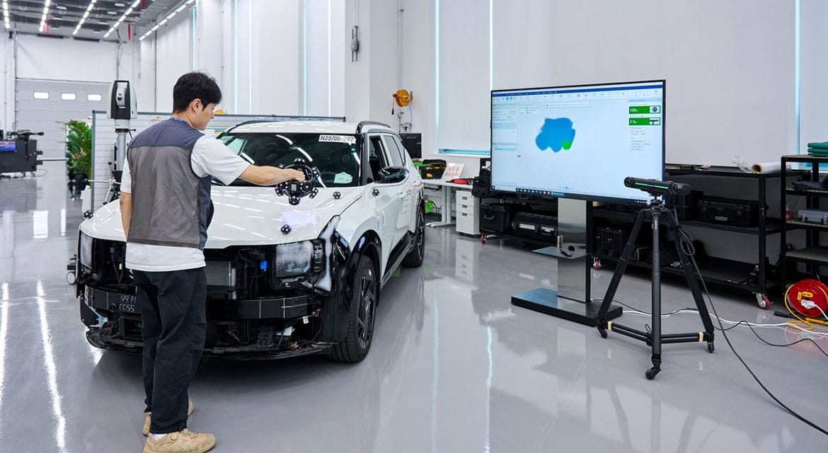 Engineers use a portable 3D scanner to verify assembly quality, helping ensure components fit and function as intended before final vehicle assembly.
