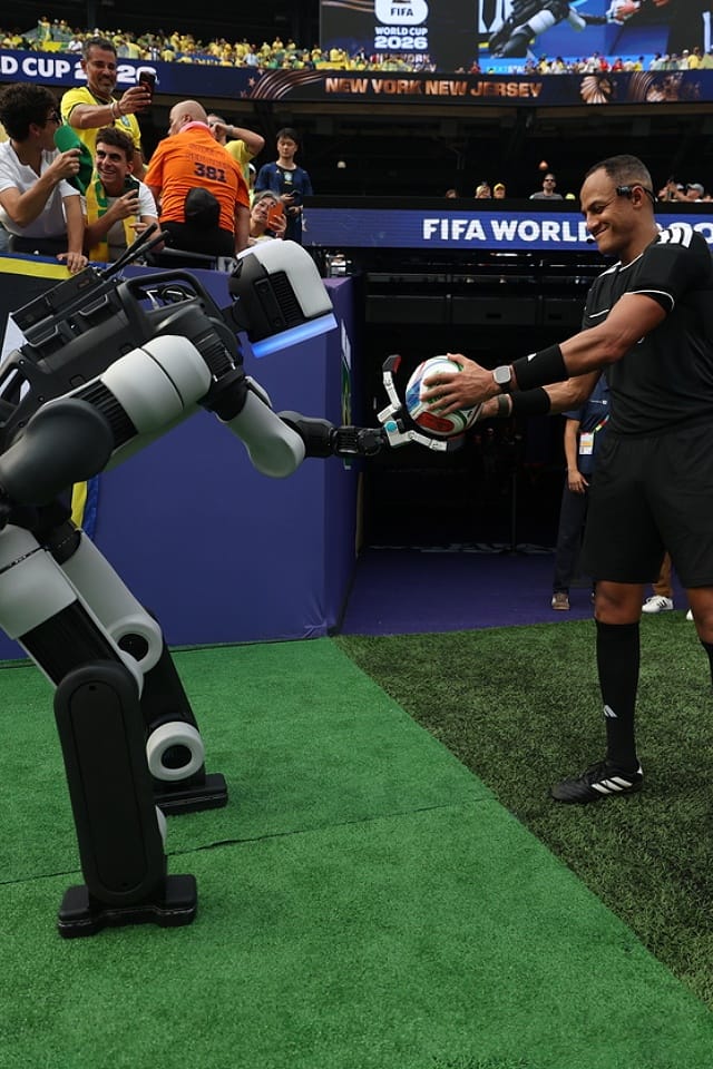 Atlas® delivers the ceremonial match ball to the referee during halftime of a Round of 16 match at New York/New Jersey Stadium at the FIFA World Cup 2026™.