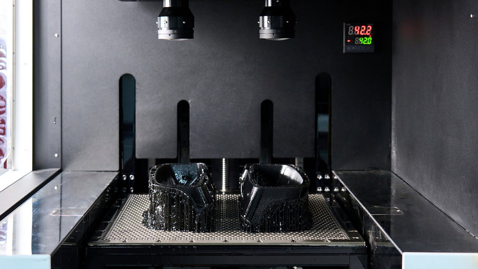 A vat photopolymerization process fabricates a component by curing liquid resin layer by layer using light.