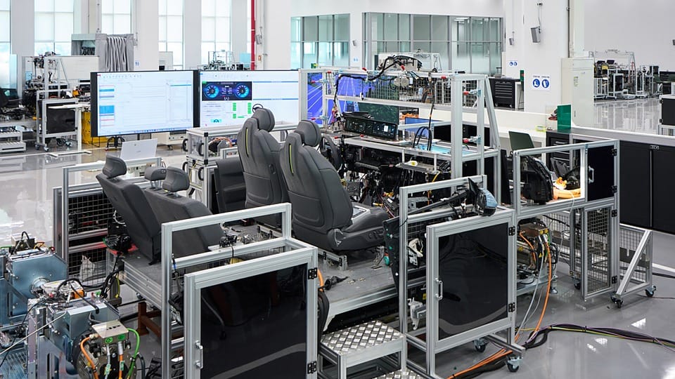 Engineer validates vehicle functions and electronic control systems using a full-scale wire-car test bench at NOVA Lab.