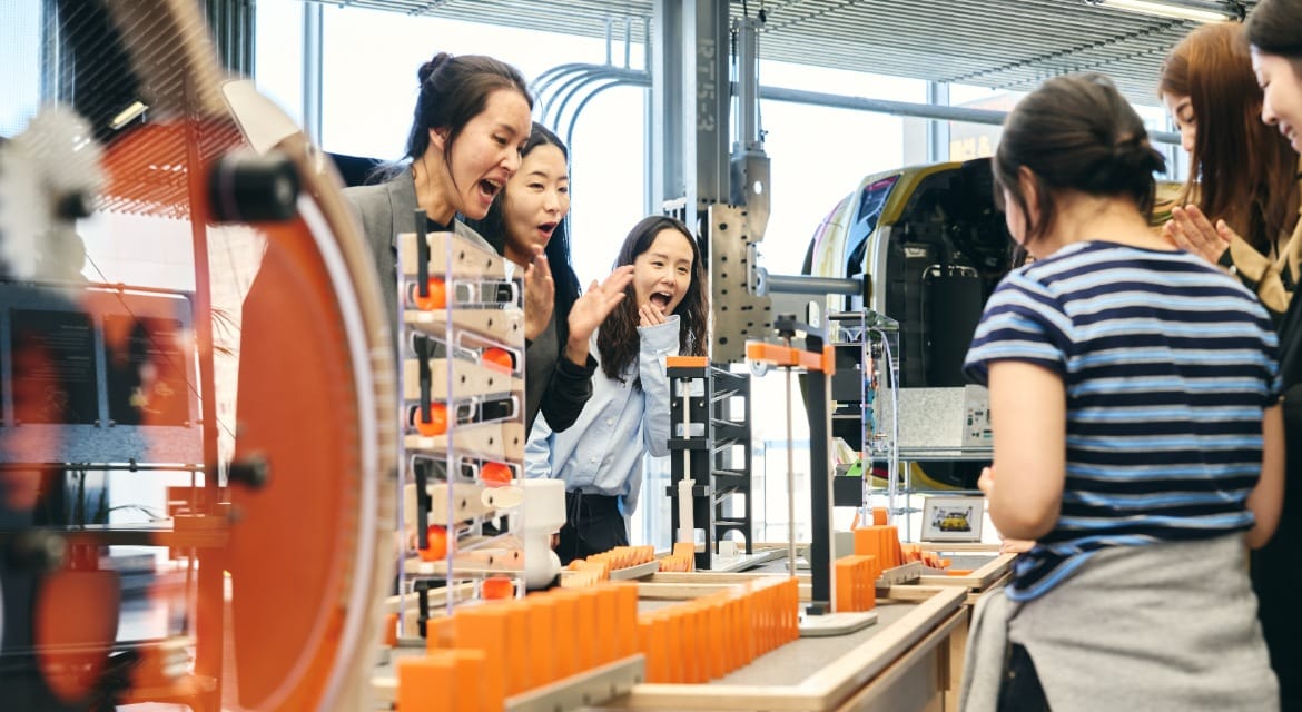 Visitors interacting with Chain Reaction, a featured exhibit in 'Have Fun with Science,' a pop-up exhibition for the GBC experiential science museum.