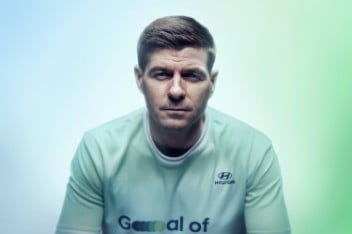 A close-up of Steven Gerrard’s face. He is looking to the left and wearing his Team Century jersey.