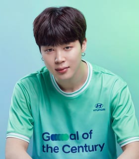 BTS member Jimin wearing a green Team Century shirt.