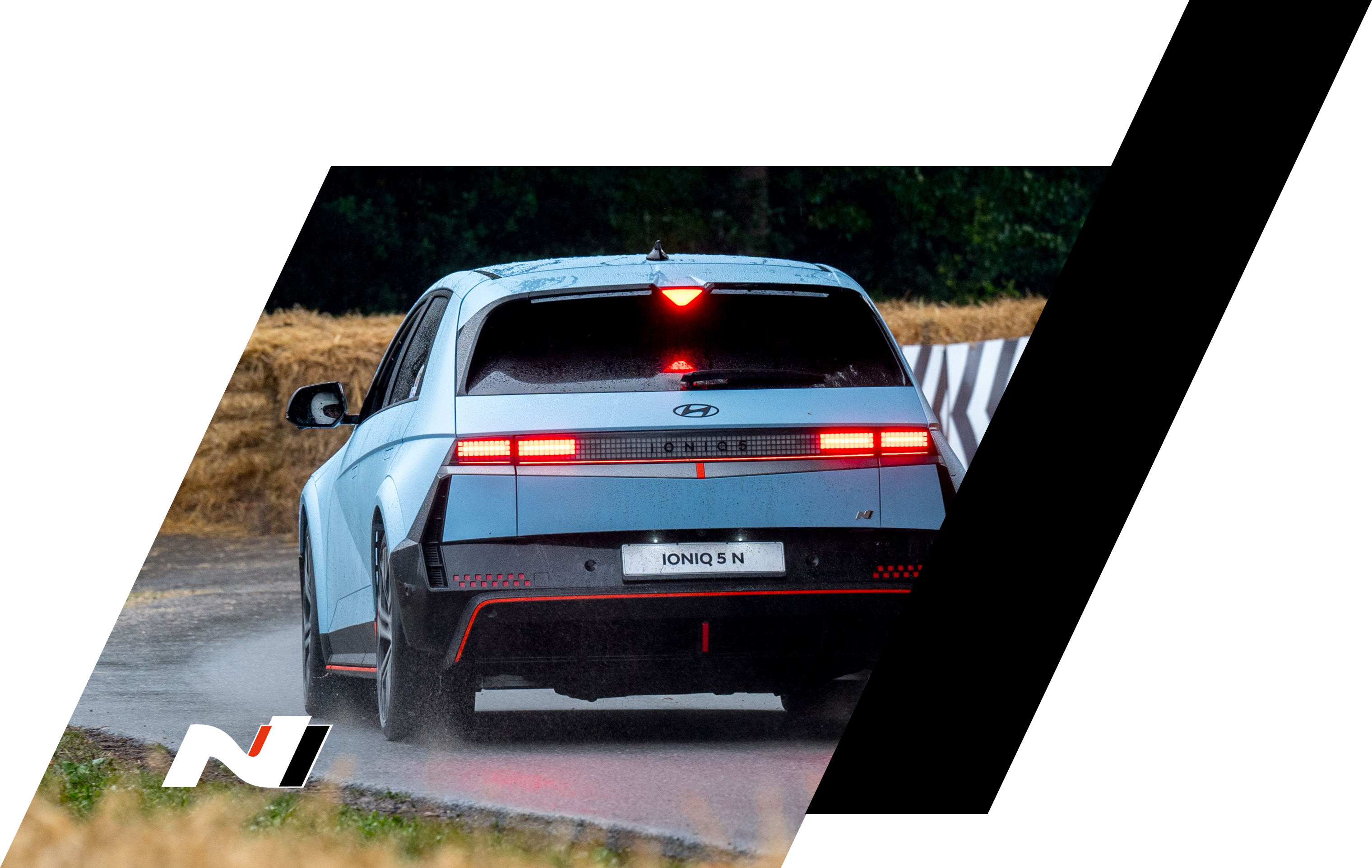 The all-electric Hyundai IONIQ 5 N driving on a race track with some trees.
